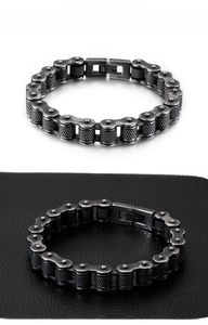 Detail of industrial bicycle chain bracelet in antique finish with knurled metal links