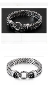 Detail of skull design stainless steel bracelet with size specs and woven chain link