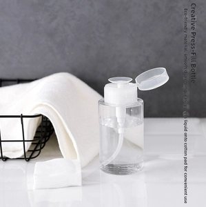 Detail of transparent press-down dispenser bottle with a pump tray for cotton pads