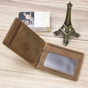 Detail of dark brown vintage cowhide wallet featuring multiple card slots and a silver money clip