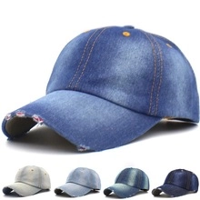 Detailed view of frayed denim baseball cap texture and vintage washed fabric finish