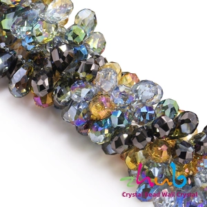 Macro shot of faceted teardrop crystal beads with iridescent AB coating and sharp edges