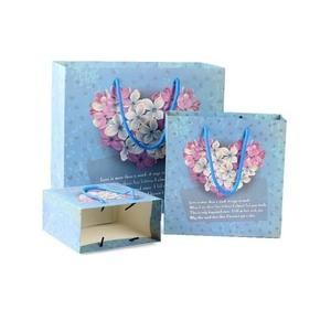 Three sky blue floral heart paper gift bags in different sizes for luxury packaging