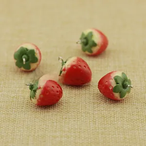 Detailed view of five 3D resin strawberry pendants with silver rings for DIY crafts