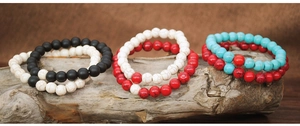 Detailed shot of 8mm natural stone beaded bracelets on vintage wood and linen background