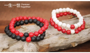 Detail shot of 8mm natural stone beaded bracelets showing matte black and white marble textures