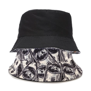 Detail of reversible bucket hat showing plain black side and dollar bill print pattern