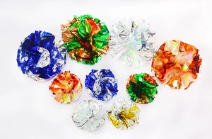 Macro detail of 6cm colorful crinkle balls with metallic foil texture for cat play