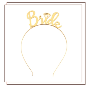 Close-up of golden metal headband with Bride lettering and diamond motif for weddings