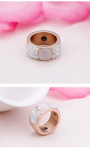 Detailed macro view of rose gold magnetic ring with opal and rainbow rhinestones