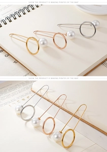 Detailed view of elegant gold, rose gold and silver long pins with pearl accents
