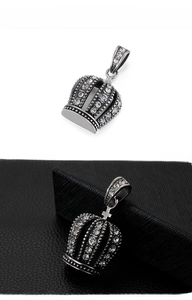 Detailed close-up of hip-hop silver crown pendant with shimmering crystal pavé stones