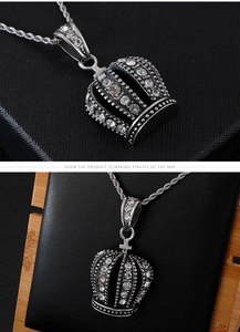 Macro view of crown hip-hop pendant with white rhinestones and twist chain detail