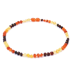 Macro shot of multicolored Baltic amber beads showing natural texture and gradient tones