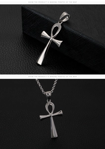 Polished silver Ankh cross pendant with wheat chain on a textured black background