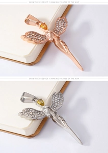 Detailed close-up of angel wing pendant with yellow pear-cut zircon and angel engraving