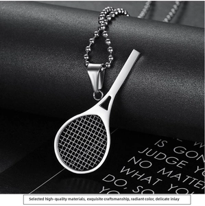 Macro shot of polished silver tennis racket pendant necklace with high-shine ball chain
