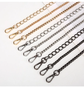 Detailed macro shot of metal chain straps in gold, silver, and gunmetal with lobster clasps