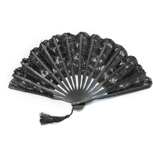 Detail of a black lace folding fan with intricate embroidery and a matching black tassel