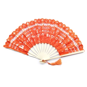 Detailed view of an orange lace folding fan with ivory wood ribs and decorative tassel