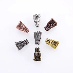 Detailed array of dragon head beads in silver, bronze, and gold metal finishes