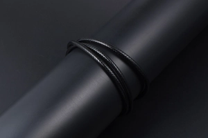 Detailed close-up of multi-layer black braided wax cord necklace with intricate woven texture