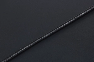 Detailed macro view showing the intricate texture of the black braided wax cord necklace