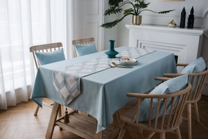 Detail of blue textured table runner with geometric patterns and tassel ornaments