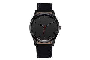 Macro detail of minimalist black quartz watch with matte dial and striking red second hand