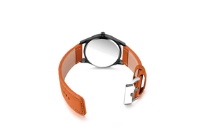 Detail view of the brown leather strap with white stitching and silver watch buckle
