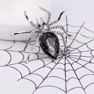 Sparkling crystal spider brooch with dark grey pear-shaped stone and silver plating