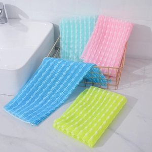 Close-up of four colorful nylon mesh bath towels with wavy texture in a gold basket