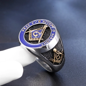 Macro side view of Freemason signet ring with blue enamel and golden compass symbol
