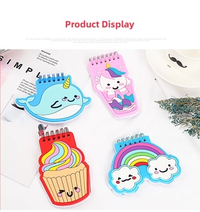 Detail view of four cartoon PVC coil notebooks featuring unicorn and cupcake 3D designs