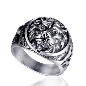 Detailed close-up of antique silver lion head carving on a stainless steel men's ring