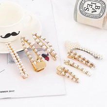 Flat lay of pearl and rhinestone hair clips set with metal base on aesthetic background