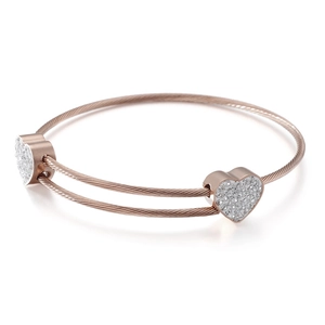 Rose gold twisted rope heart bracelet with sparkling pavé crystals on white background