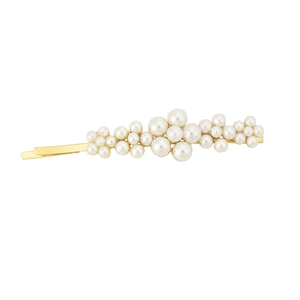 Macro detail of elegant gold-tone hair clip featuring lustrous white pearl clusters