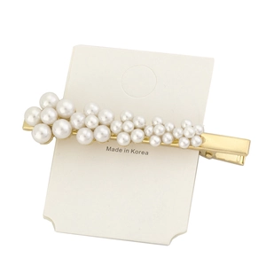 Detailed macro view of an elegant gold pearl hair clip on a white Korean product card