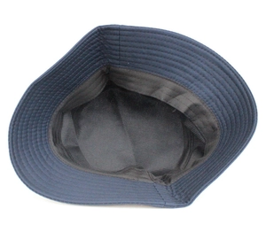 Close-up of the inner lining and reinforced stitching on a navy cotton bucket hat