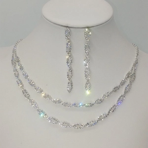 Close-up of double-layered silver necklace and earrings with marquise-cut crystals