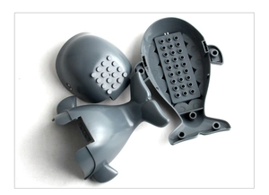 Detailed view of grey shark building block components with interlocking studs and internal structure