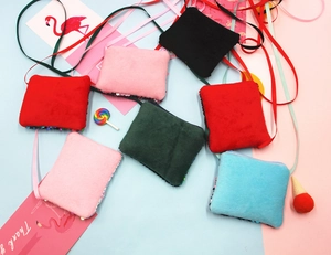 Collection of colorful plush and sequin mini crossbody coin purses for children.