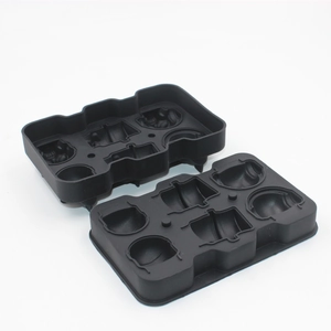 Macro shot of black silicone ice cube trays featuring detailed stormtrooper helmet cavities