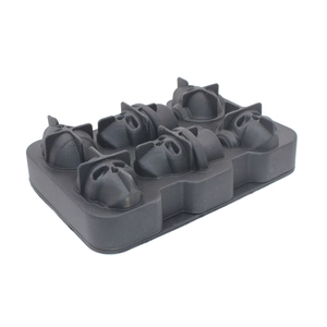 Detailed macro view of 6-hole black silicone ice cube mold in skull top hat shapes