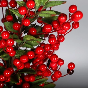 Artificial red berry branch with glossy berries and green leaves for Christmas DIY decor