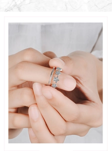 Detail shot of a double-layered silver star ring set with zircon stones on model hand