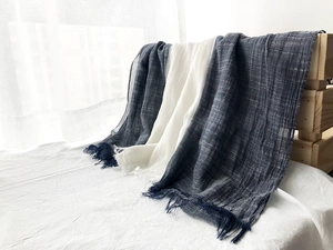 Detailed close-up of navy and white cotton linen scarf with soft fringe edges