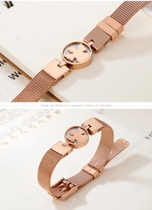 Macro detail of rose gold mesh band bracelet featuring a hollow angel bear centerpiece
