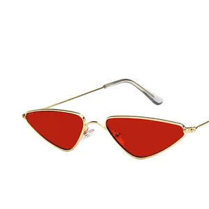 Fashionable triangle cat eye sunglasses with gold metal frame and red translucent lenses